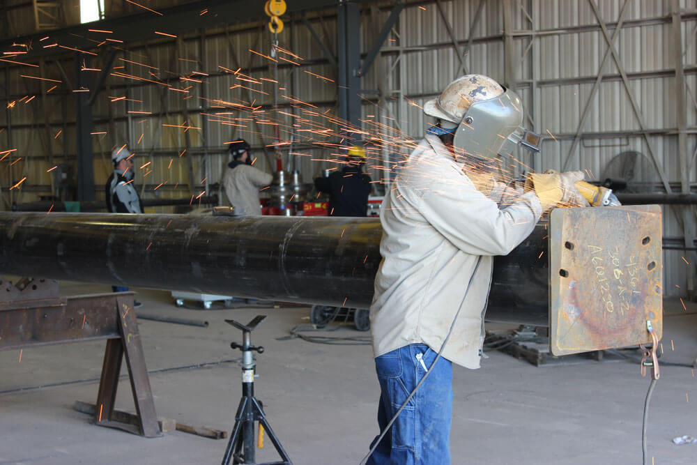 worker cutting pipe